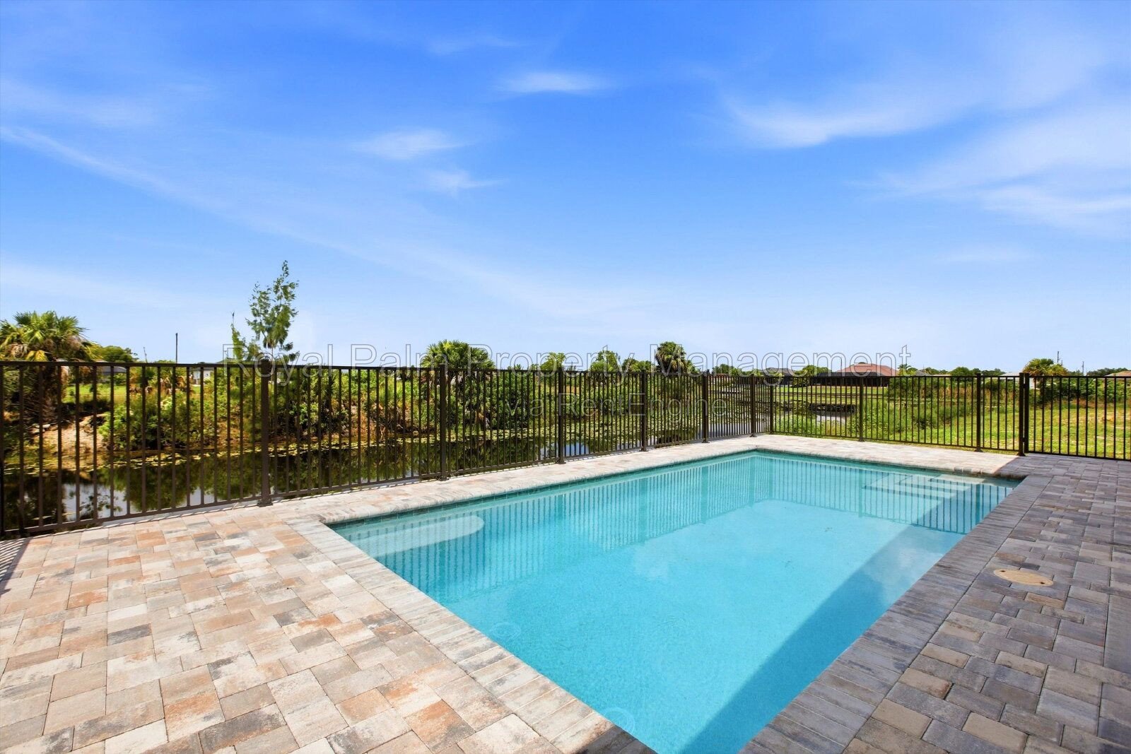 New 3/2 Pool Home for Rent on Canal, Fenced Yard, Pets Welcome. Your Dog Approves of This Backyard property image